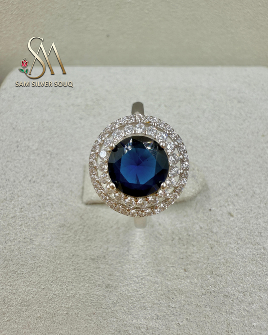 SIVLER RING WITH DARK BLUE COLORED STONE