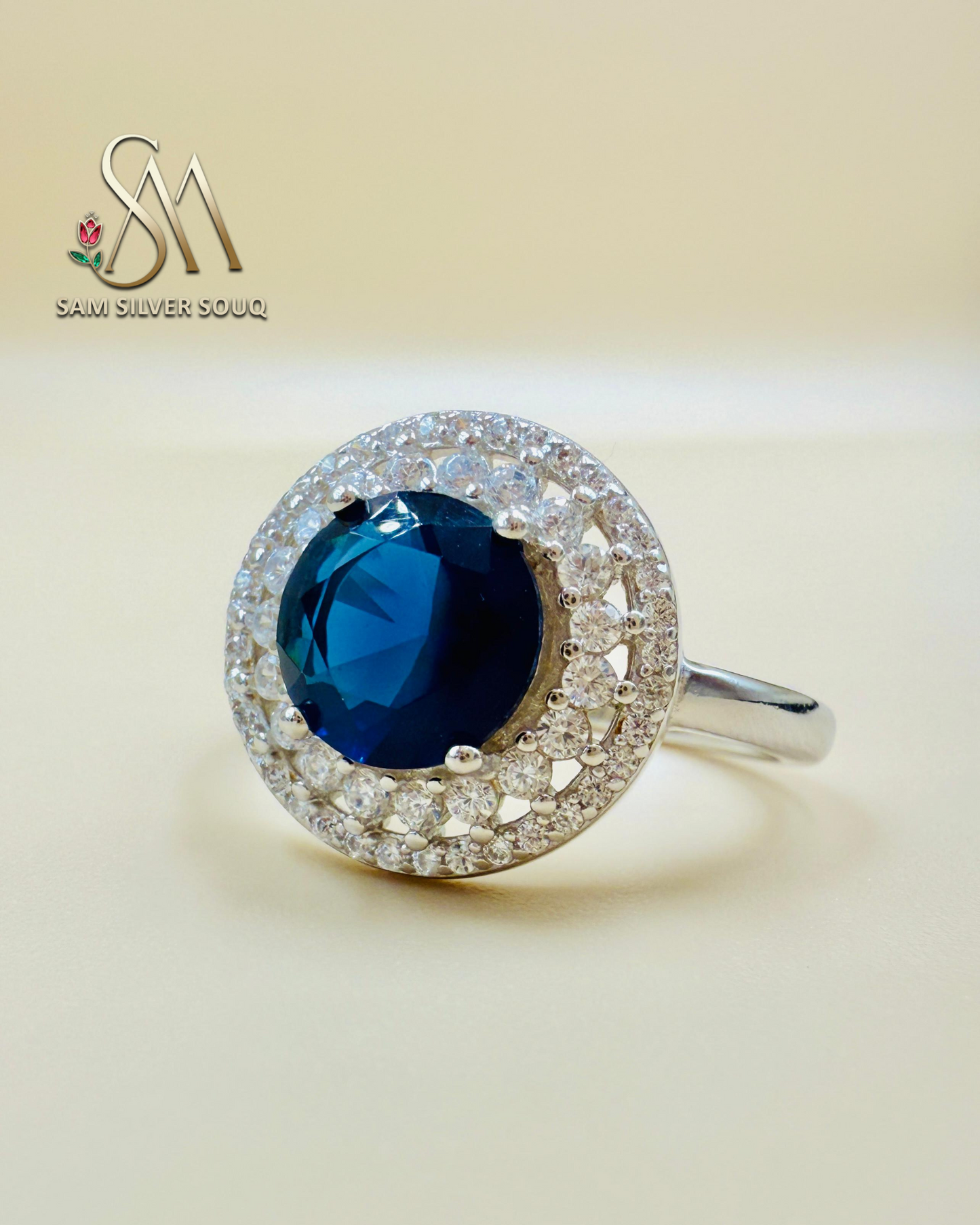 SIVLER RING WITH DARK BLUE COLORED STONE