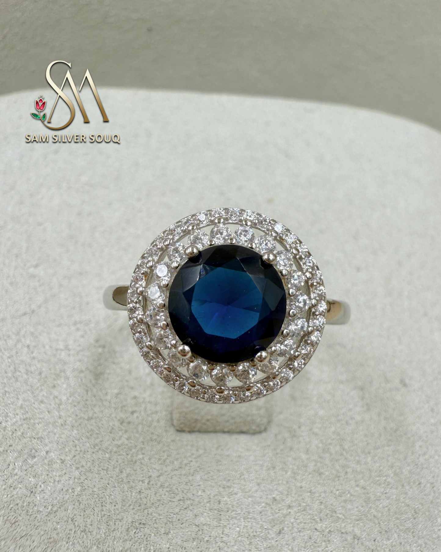 SIVLER RING WITH DARK BLUE COLORED STONE